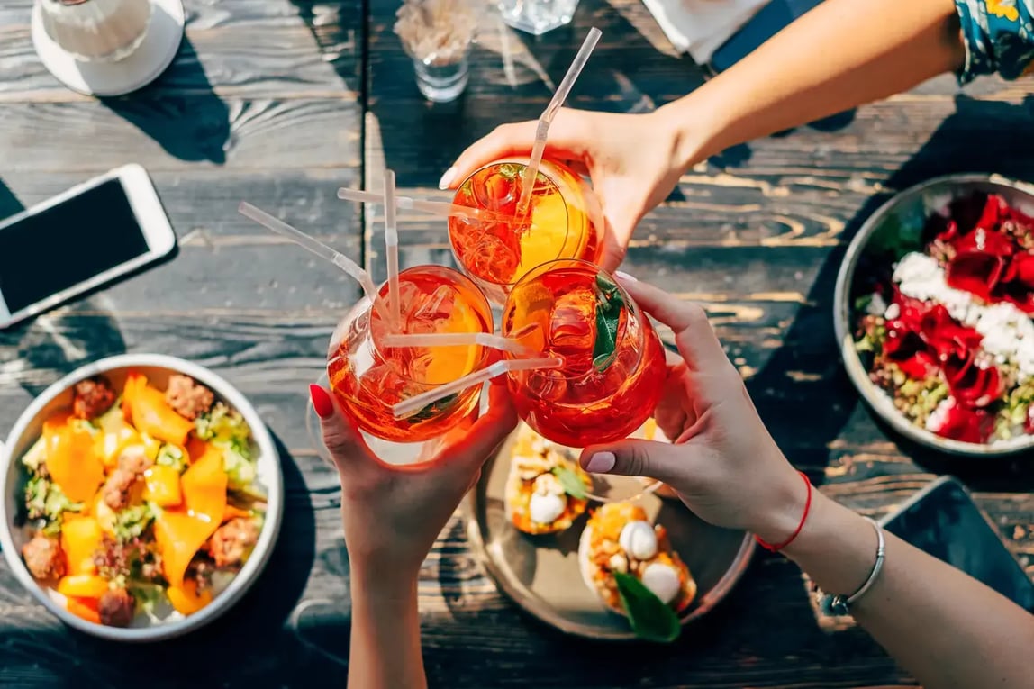 People Toasting Aperol Spritz - Image by Dulin / Shutterstock.com